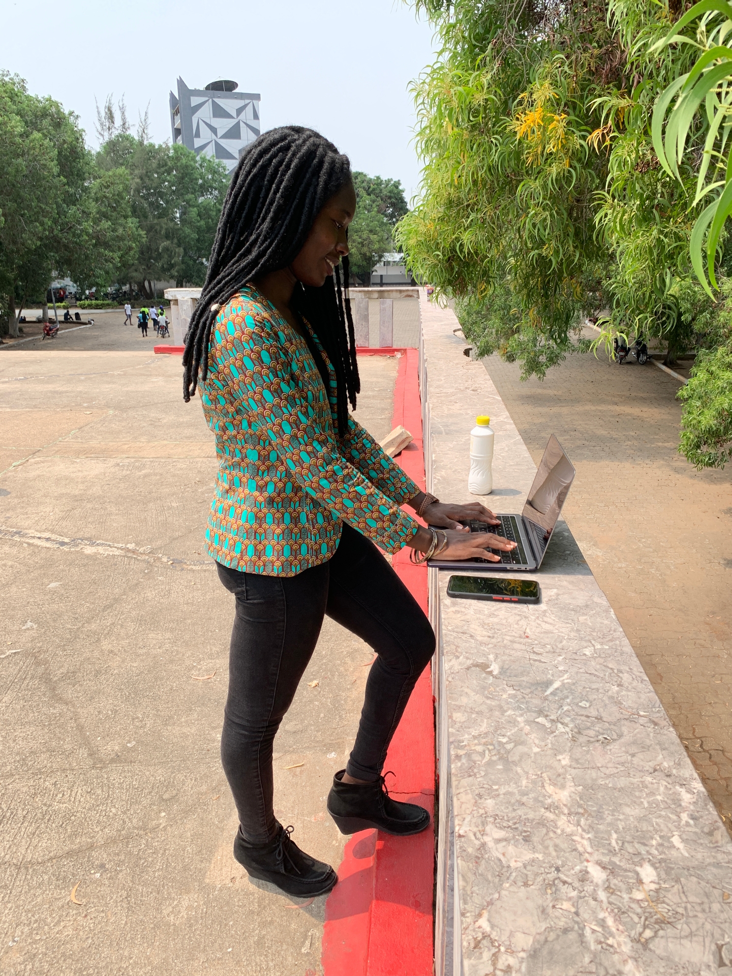 Student on campus uploading assignments on the Learning Management System (LMS) and downloading course content for reading at home.