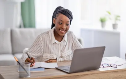 Woman sitting at desk using laptop to study